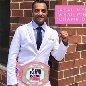 dr tarak patel wearing a championship belt